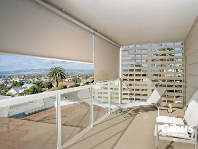 Porch overlooking city with ocean view